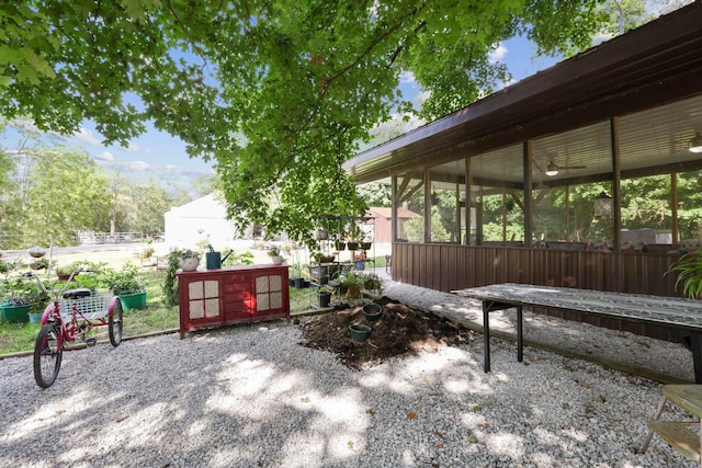 view of patio featuring a sunroom