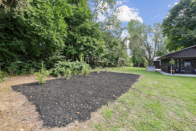 view of yard with a playground and a patio area