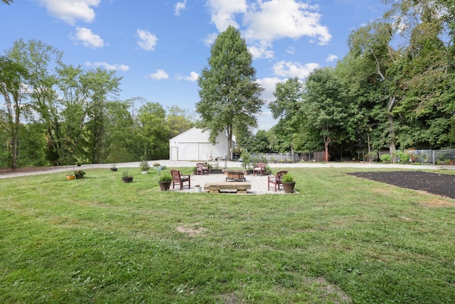 view of yard with an outbuilding and an outdoor fire pit