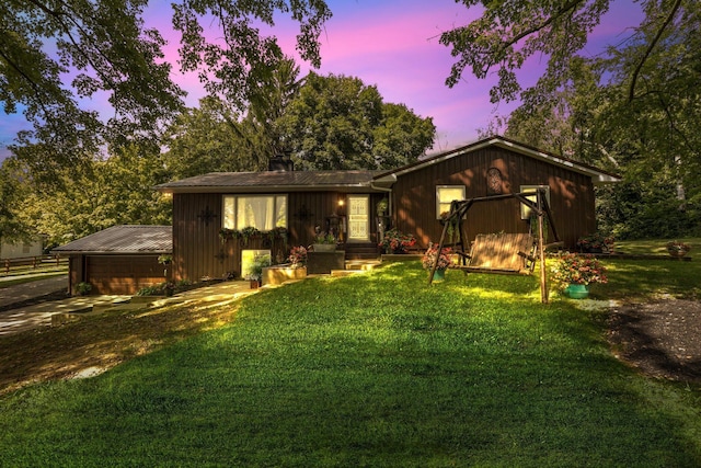 ranch-style home featuring a yard