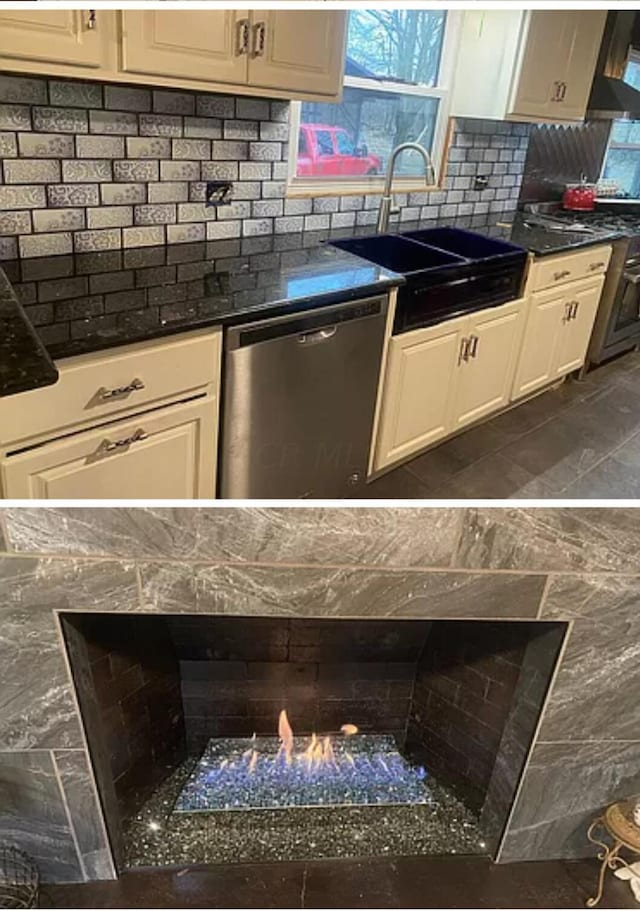 kitchen with decorative backsplash, stainless steel appliances, premium range hood, and sink