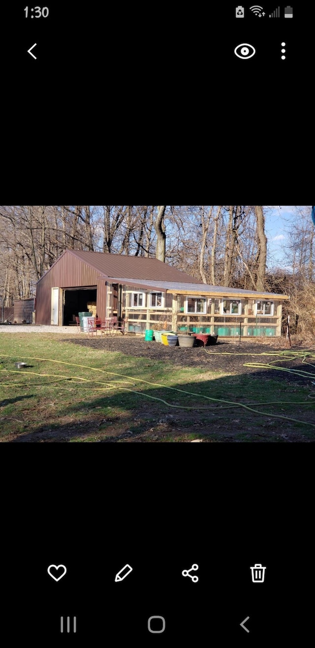 back of property featuring an outbuilding and a pool