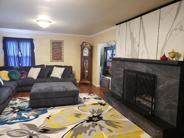 living room with a high end fireplace, dark wood-type flooring, and ornamental molding