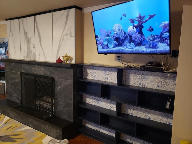 room details featuring crown molding, a fireplace, and hardwood / wood-style floors