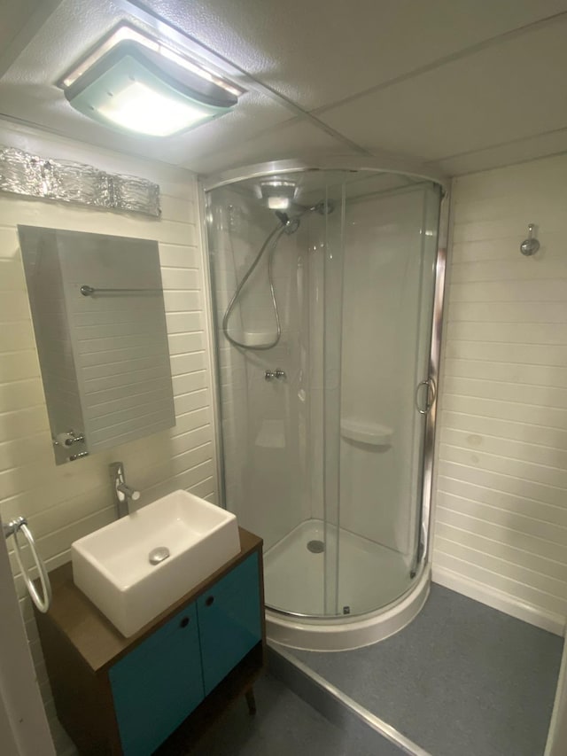 bathroom featuring vanity and an enclosed shower