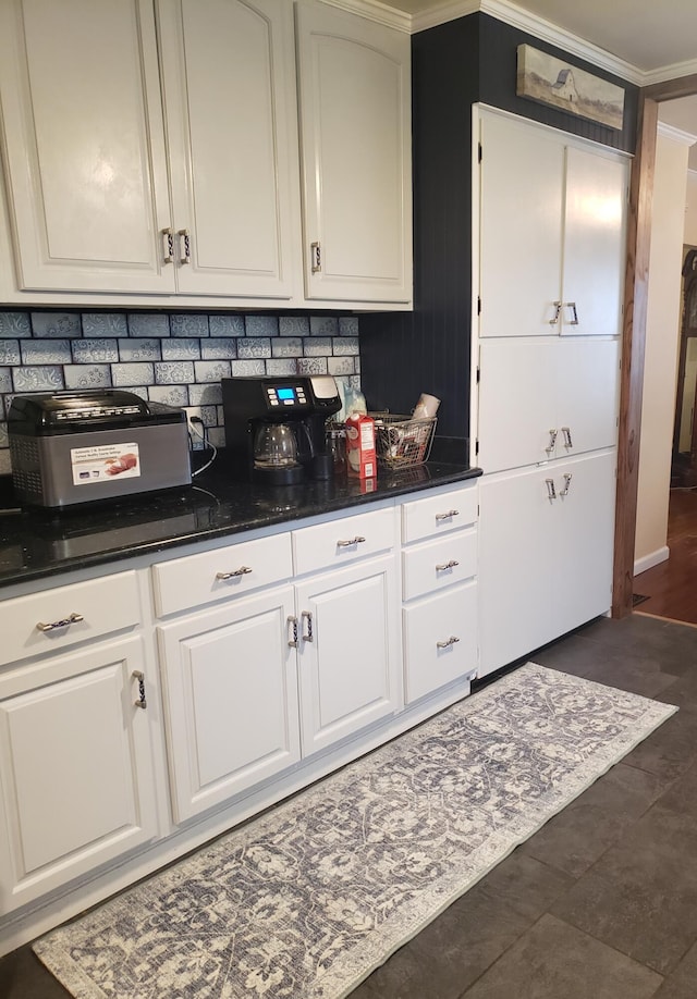 kitchen featuring white cabinetry, crown molding, and tasteful backsplash