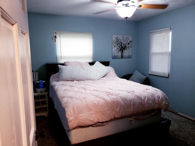 bedroom with dark colored carpet and ceiling fan