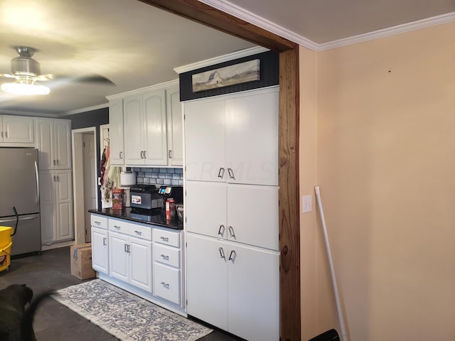 kitchen with stainless steel refrigerator, ceiling fan, tasteful backsplash, crown molding, and white cabinets