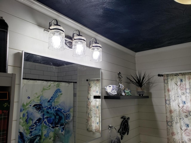 bathroom with curtained shower, wooden walls, and ornamental molding