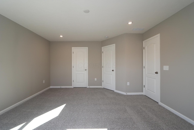 unfurnished bedroom with light colored carpet