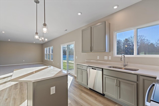 kitchen featuring light wood-type flooring, gray cabinetry, stainless steel appliances, sink, and pendant lighting