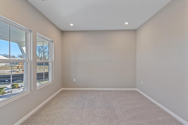 carpeted spare room featuring a wealth of natural light