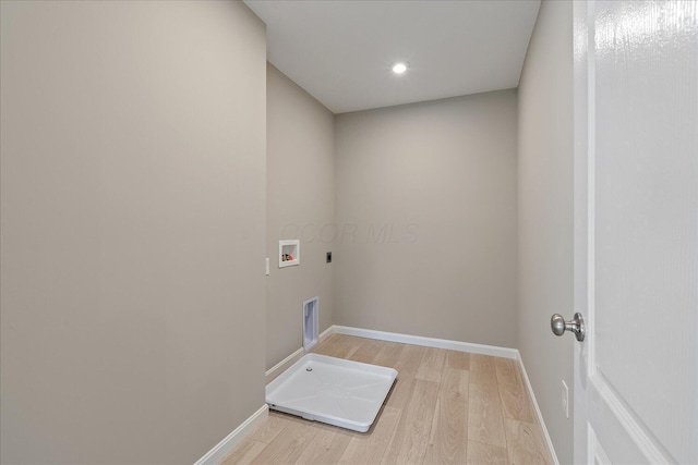 washroom featuring hookup for an electric dryer, hookup for a washing machine, and light hardwood / wood-style floors