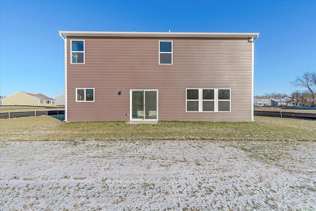 rear view of property with a yard