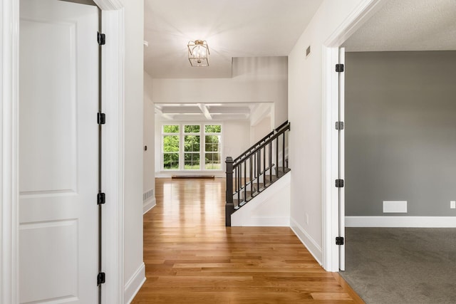 hallway with light hardwood / wood-style floors