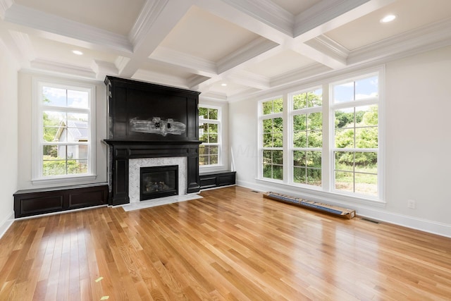 unfurnished living room with coffered ceiling, a premium fireplace, beamed ceiling, crown molding, and hardwood / wood-style flooring