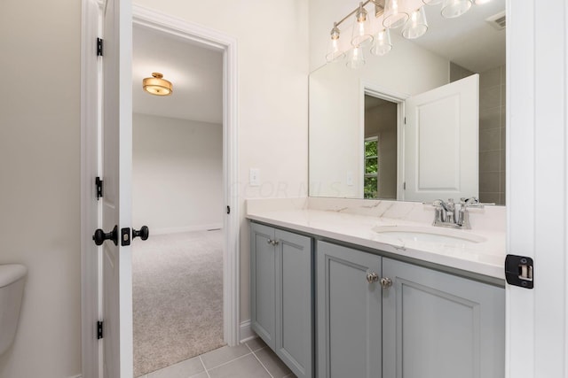 bathroom with tile patterned floors, vanity, and toilet