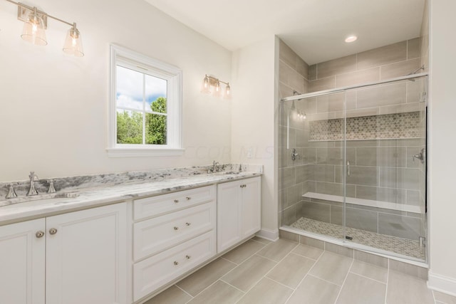 bathroom featuring vanity, tile patterned floors, and an enclosed shower