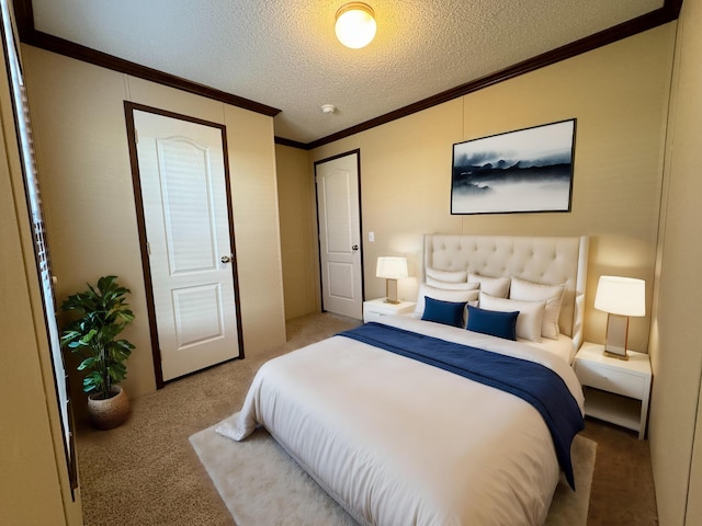 carpeted bedroom with ornamental molding and a textured ceiling