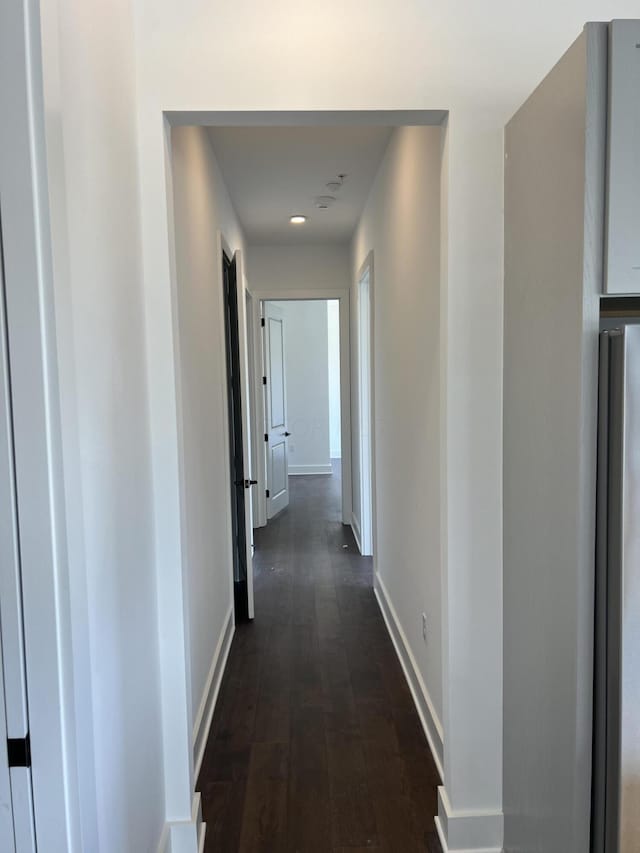 corridor with dark hardwood / wood-style floors