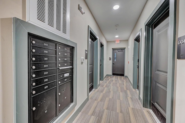 hall featuring mail boxes and light hardwood / wood-style floors