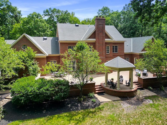 back of house featuring a gazebo, a patio, and a deck