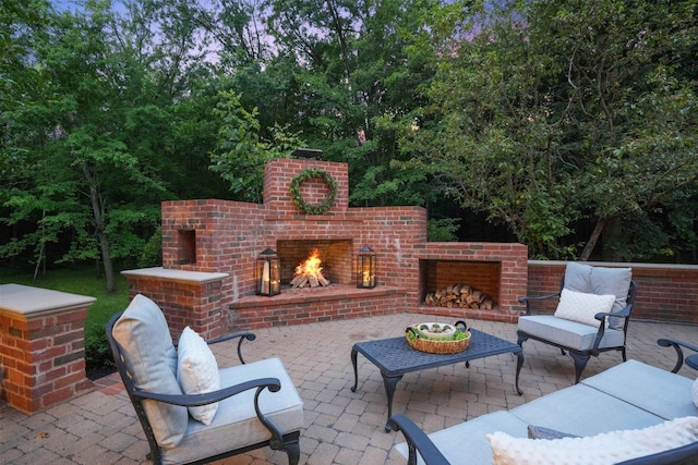 view of patio featuring an outdoor brick fireplace