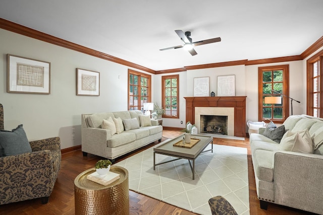 living room featuring ceiling fan, plenty of natural light, and ornamental molding