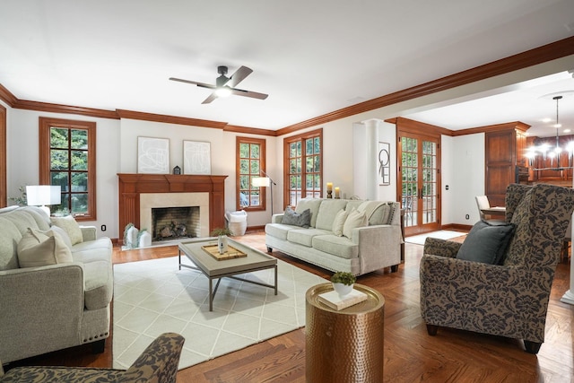 living room with a high end fireplace, french doors, parquet floors, ornamental molding, and ceiling fan