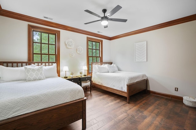 bedroom featuring crown molding, ceiling fan, and dark wood-type flooring