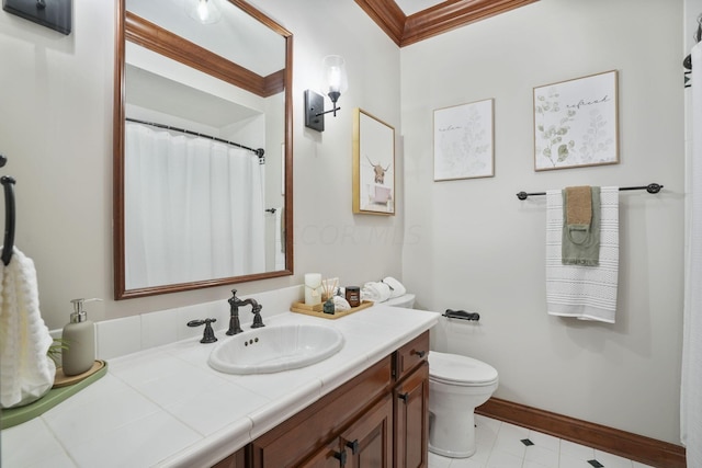 bathroom with vanity, toilet, and ornamental molding