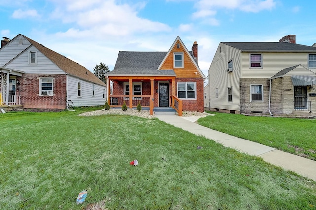 1468 E Whittier St, Columbus, OH 43206 - view of front of house with covered porch, brick siding, a front lawn, and roof with shingles