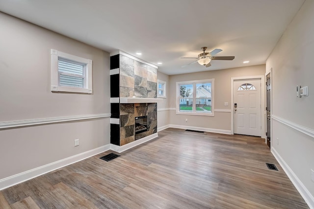 1468 E Whittier St, Columbus, OH 43206 - unfurnished living room featuring ceiling fan, a fireplace, wood finished floors, and recessed lighting