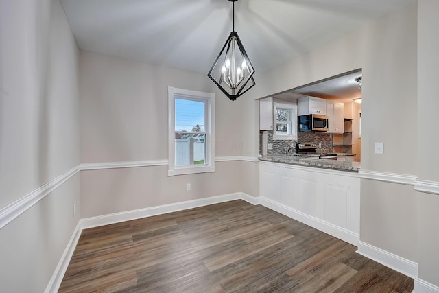 1468 E Whittier St, Columbus, OH 43206 - unfurnished dining area featuring dark wood-style flooring and a chandelier