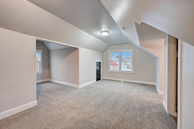 1468 E Whittier St, Columbus, OH 43206 - additional living space with light carpet, healthy amount of natural light, and lofted ceiling
