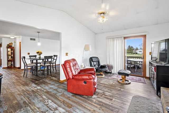 living room with dark hardwood / wood-style flooring, vaulted ceiling, and ceiling fan