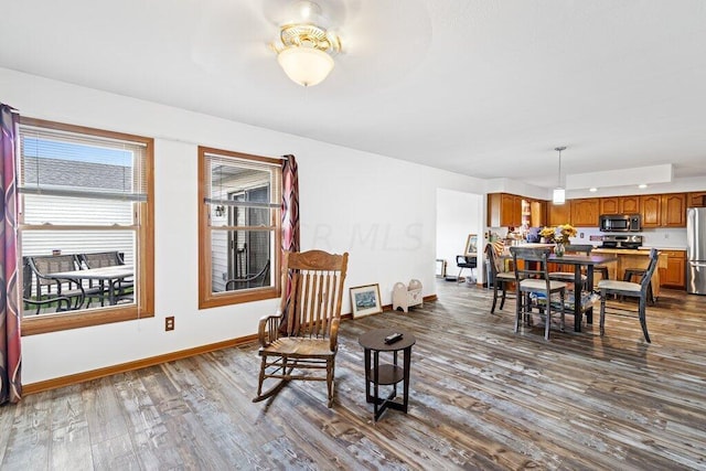 dining area featuring wood-type flooring and ceiling fan