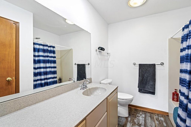 full bathroom with hardwood / wood-style flooring, vanity, toilet, and shower / bath combo