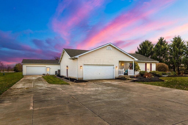 view of front of home with a porch, a garage, and a yard