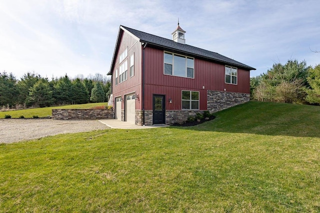 view of side of home with a garage and a yard