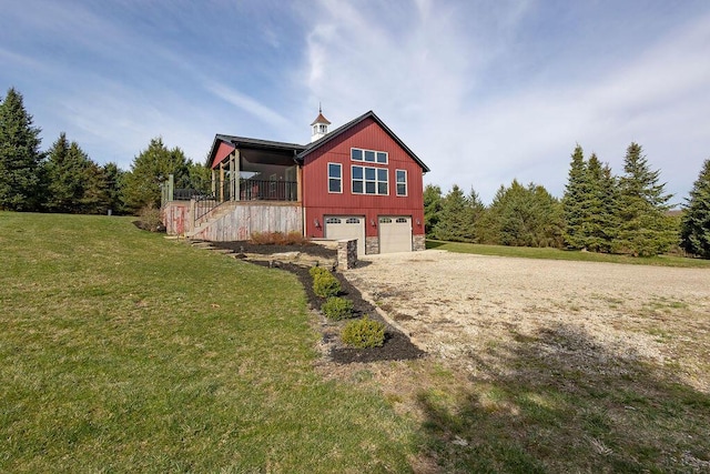 back of property featuring a lawn, a porch, and a garage