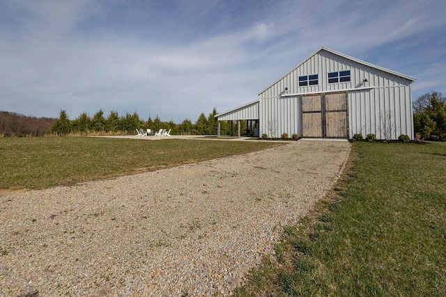 view of outbuilding with a yard