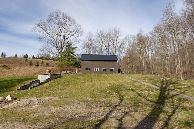 view of yard with an outbuilding and a rural view