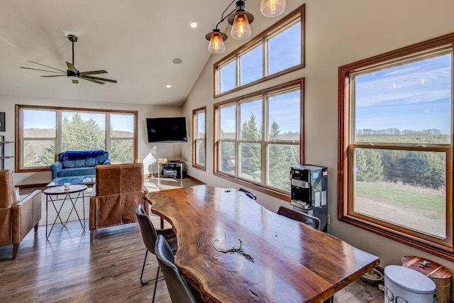 office area with ceiling fan with notable chandelier, hardwood / wood-style flooring, and lofted ceiling