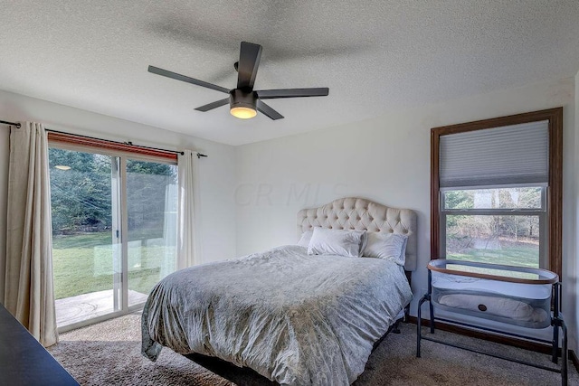 bedroom featuring a textured ceiling, access to outside, multiple windows, and ceiling fan