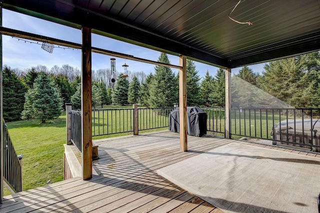 wooden deck featuring grilling area and a lawn