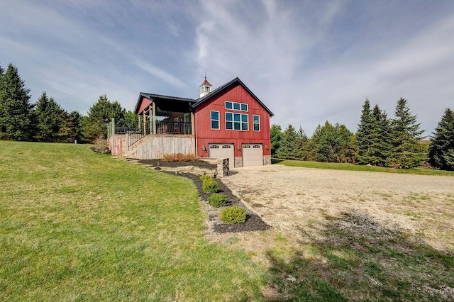 back of property featuring a yard and a garage