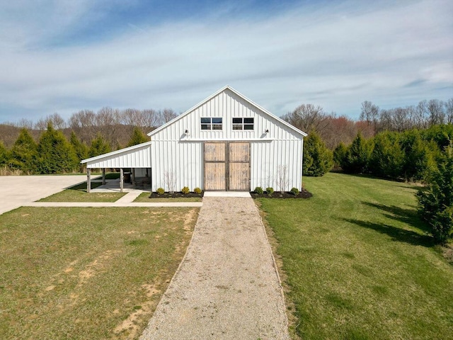 view of outdoor structure with a lawn and a carport