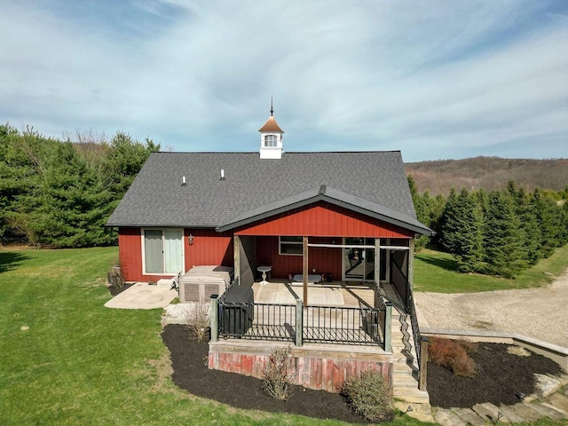 rear view of property with a patio area and a lawn