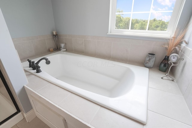 bathroom featuring a washtub and tile patterned floors